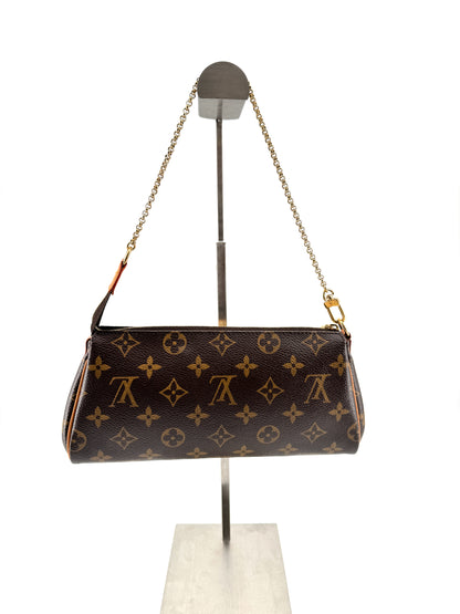 LOUIS VUITTON EVA MONOGRAM – Pochette en toile enduite avec chaîne dorée et bandoulière cuir