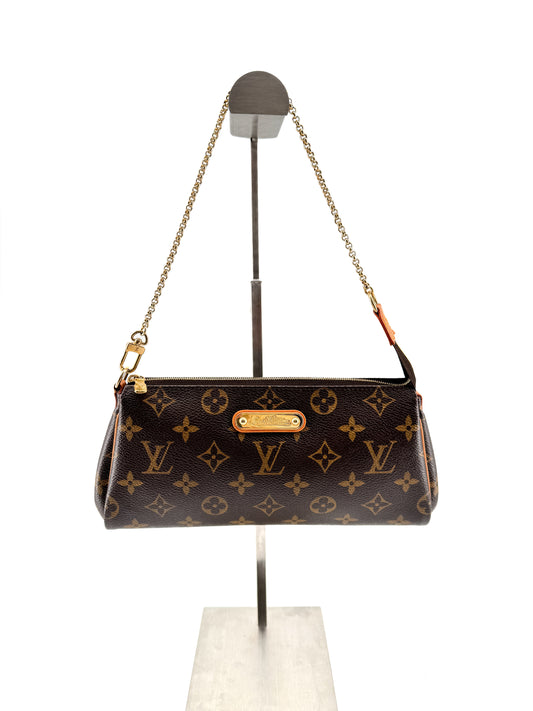 LOUIS VUITTON EVA MONOGRAM – Pochette en toile enduite avec chaîne dorée et bandoulière cuir